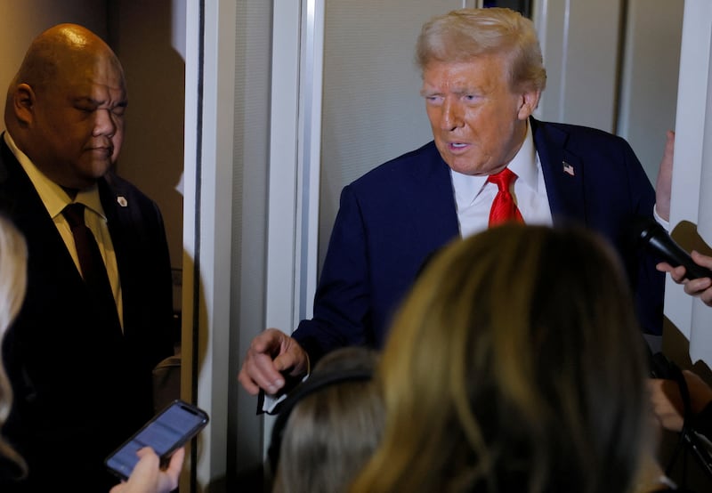 Steven Cheung listens to Donald Trump.