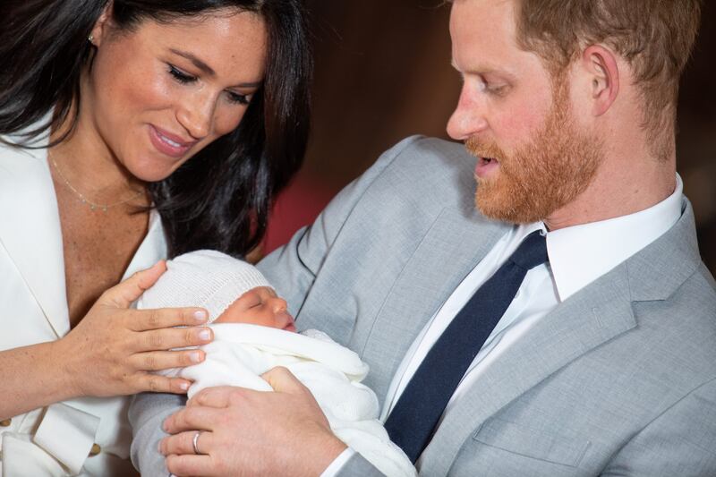 Britain's Prince Harry and Meghan, Duchess of Sussex hold their baby son, who was born on Monday morning, during a photocall in St George's Hall at Windsor Castle, in Berkshire, Britain May 8, 2019.