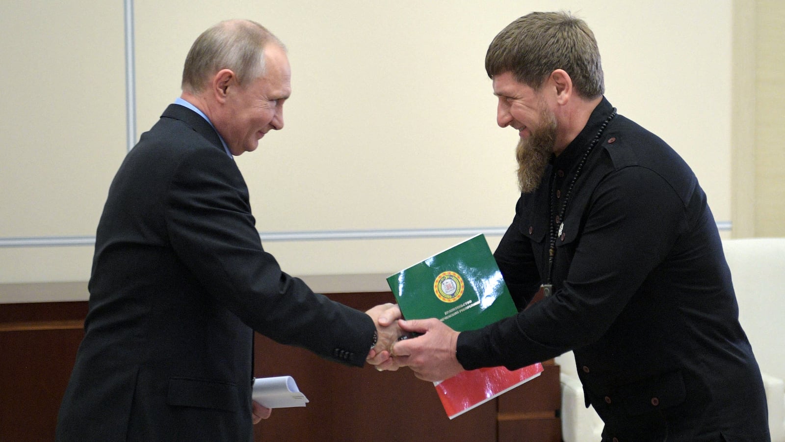 Russian President Vladimir Putin shakes hands with Chechen leader Ramzan Kadyrov.