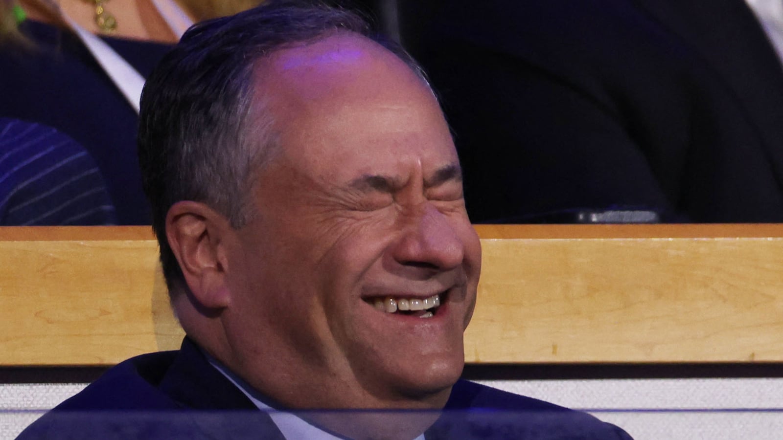 Doug Emhoff closes his eyes while laughing.