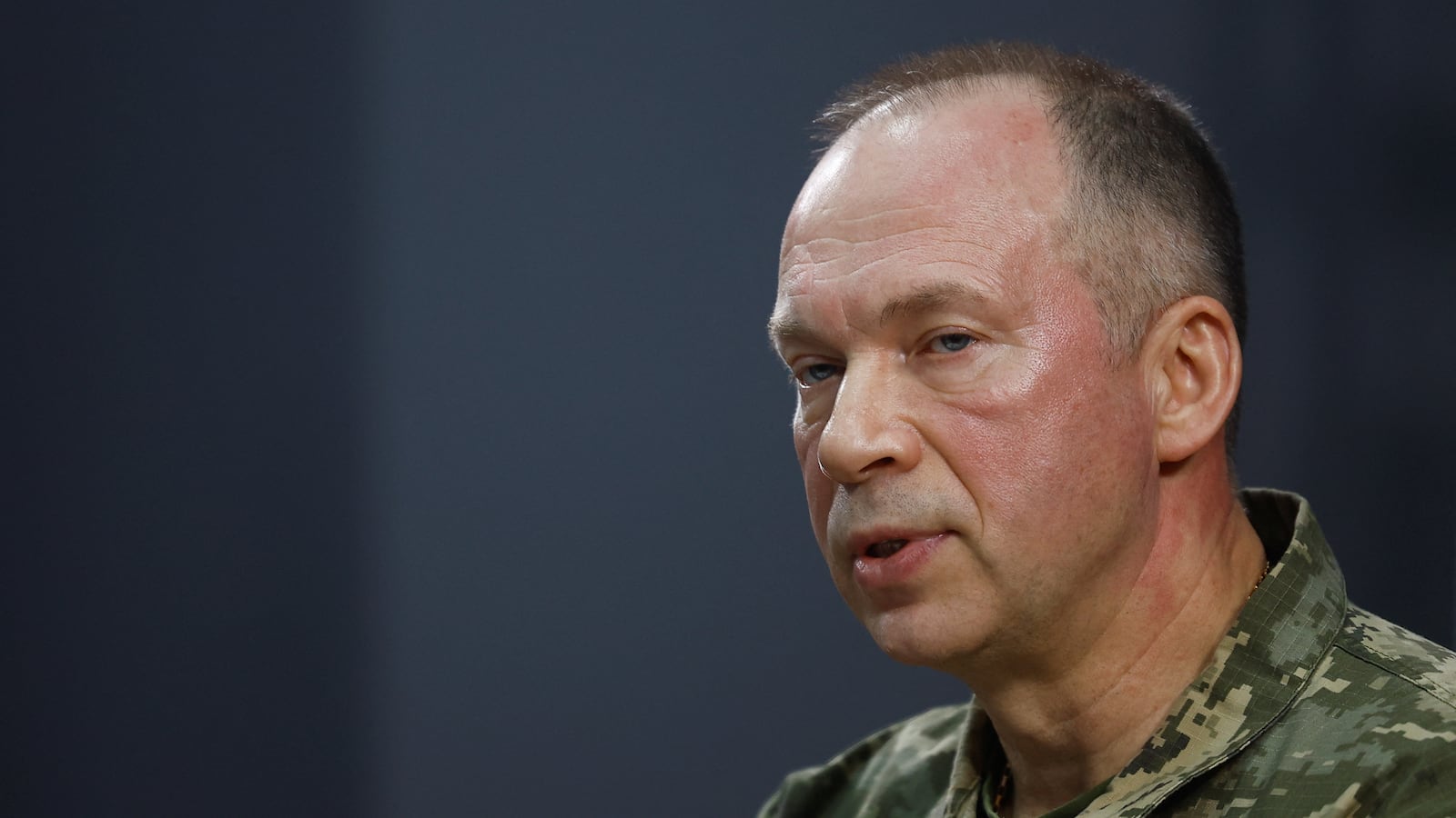 Colonel general Oleksandr Syrskyi pictured before a blue background