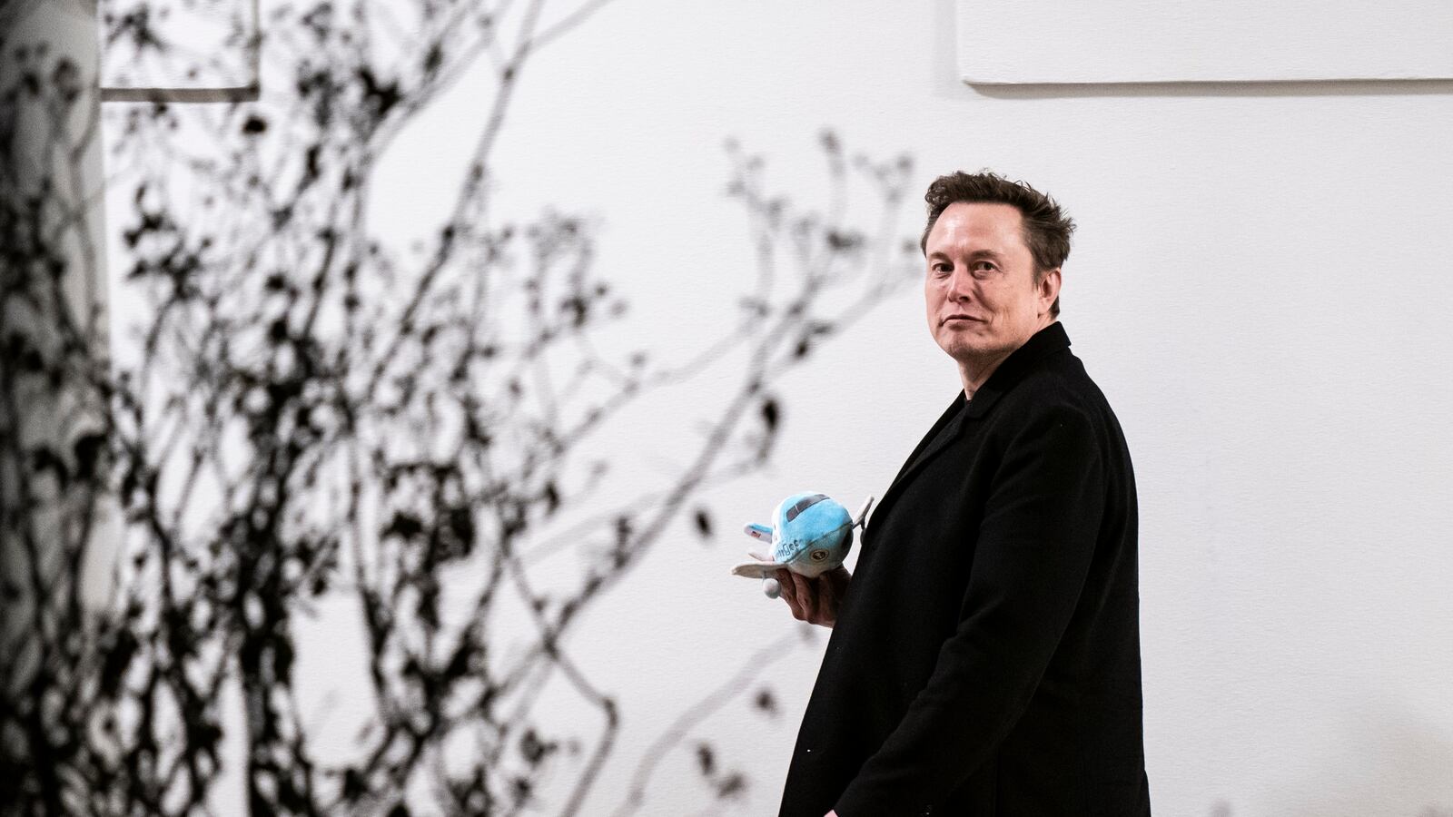 Elon Musk carries a stuffed Air Force One as he walks back to the West Wing along the colonnade after returning to the White House on Marine One with President Donald Trump on Wednesday, Feb 19, 2025 in Washington, DC.