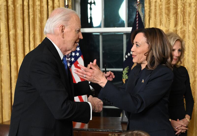 WASHINGTON, DC - JANUARY 15: US President Joe Biden and Vice-President Kamala Harris go for a hug as Second Gentleman Doug Emhoff looks on after the President delivered his farewell address to the nation from the Oval Office of the White House on January 15, 2025 in Washington, DC. (Photo by Mandel Ngan - Pool/Getty Images)