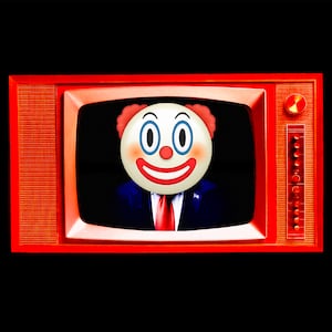 A photo illustration of the White House's Donald Trump ad with a clown emoji.