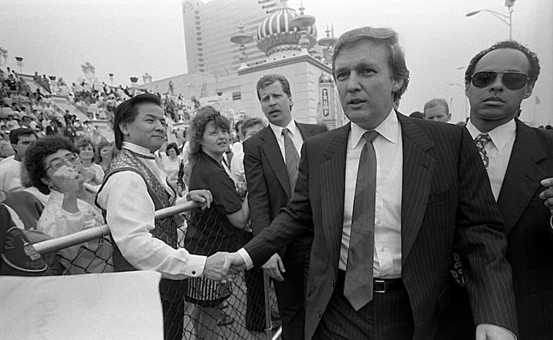Donald Trump shakes hands with the crowd outside Trump Taj Mahal during his Birthday Party on June 26, 1990.