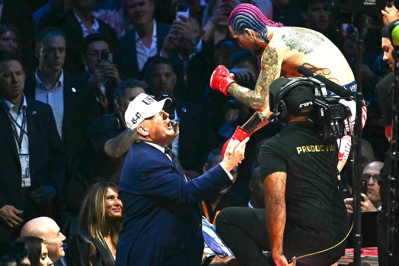 U.S. President Donald Trump speaks with America's Sean O'Malley after O'Malley defeated Canada's Aiemann Zahabi