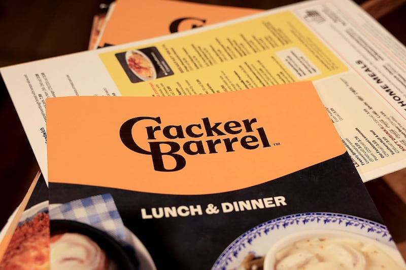 The new Cracker Barrel logo is seen on a menu inside the restaurant on August 21, 2025 in Pembroke Pines, Florida. The restaurant unveiled a new logo earlier this week as part of a larger brand refresh. The new logo removes the image of a man sitting next to a barrel and the phrase “old country store”. Now the logo will feature the words “Cracker Barrel” against a yellow background.
