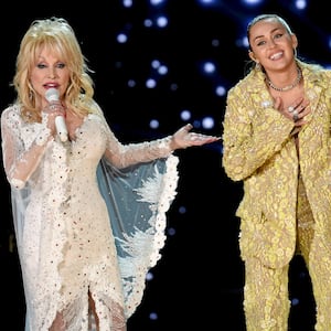 Dolly Parton (L) and Miley Cyrus perform onstage during the 61st Annual GRAMMY Awards in 2019.