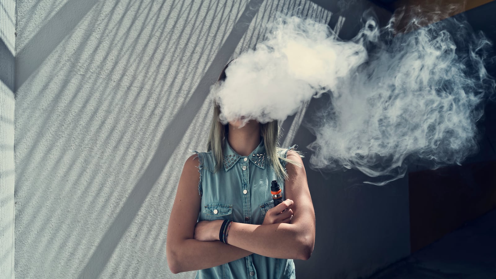 Young women smoking a vape.
