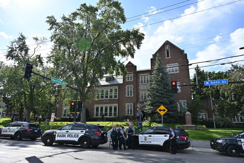 Police and first responders work at the scene of a shooting near Annunciation Church and Catholic School in Minneapolis, Minneosta, on Aug. 27, 2025. Two children were shot dead when a gunman attacked a Minneapolis church on Wednesday, with 17 people injured, 14 of them children, police said. The gunman "began firing a rifle through the church windows towards the children sitting in the pews at the mass," Minneapolis police chief Brian O'Hara told reporters. The pupils were marking the first week of the school year when the attack occurred.