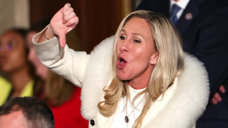 Marjorie Taylor Greene booing and giving a thumbs down gesture at Biden's State of the Union.