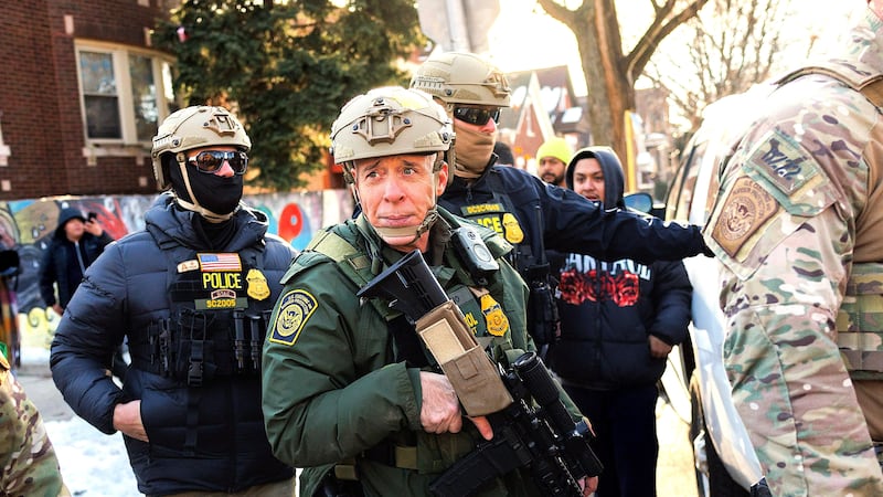 U.S. Border Patrol Cmdr. Gregory Bovino is confronted by residents and protesters during an immigration operation in Little Village