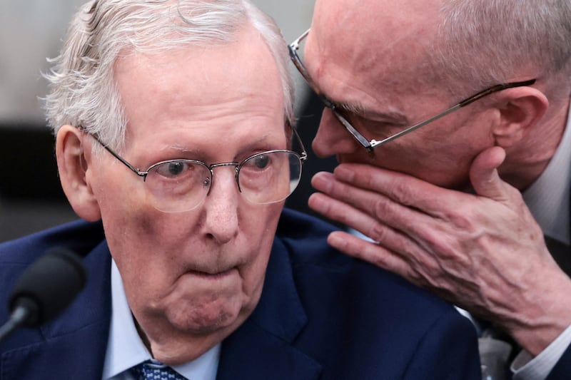 An aide whispers to U.S. Senator Mitch McConnell (R-KY) as he participates in a Senate Agriculture Committee meeting on whether to vote the farm bill out of committee on Capitol Hill in Washington, D.C., U.S., September 16, 2026.