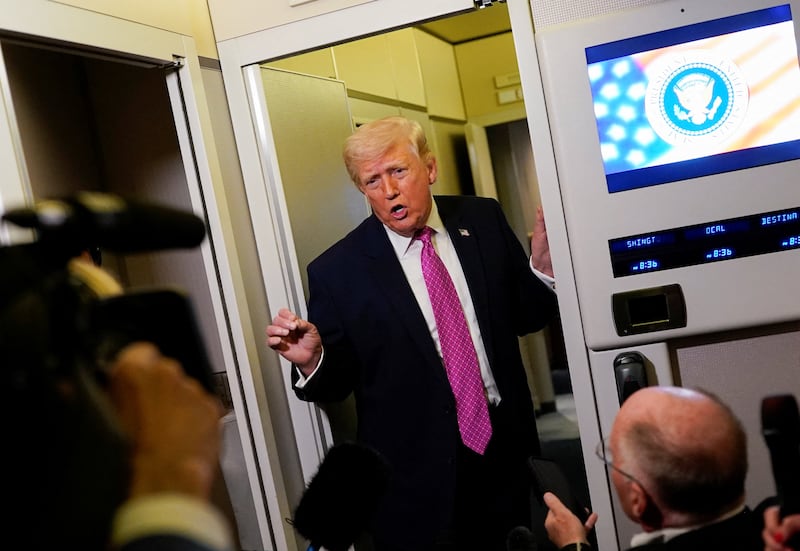 U.S. President Donald Trump talks to members of the media aboard Air Force One en route to Joint Base Andrews, Maryland, U.S., March 29, 2026.