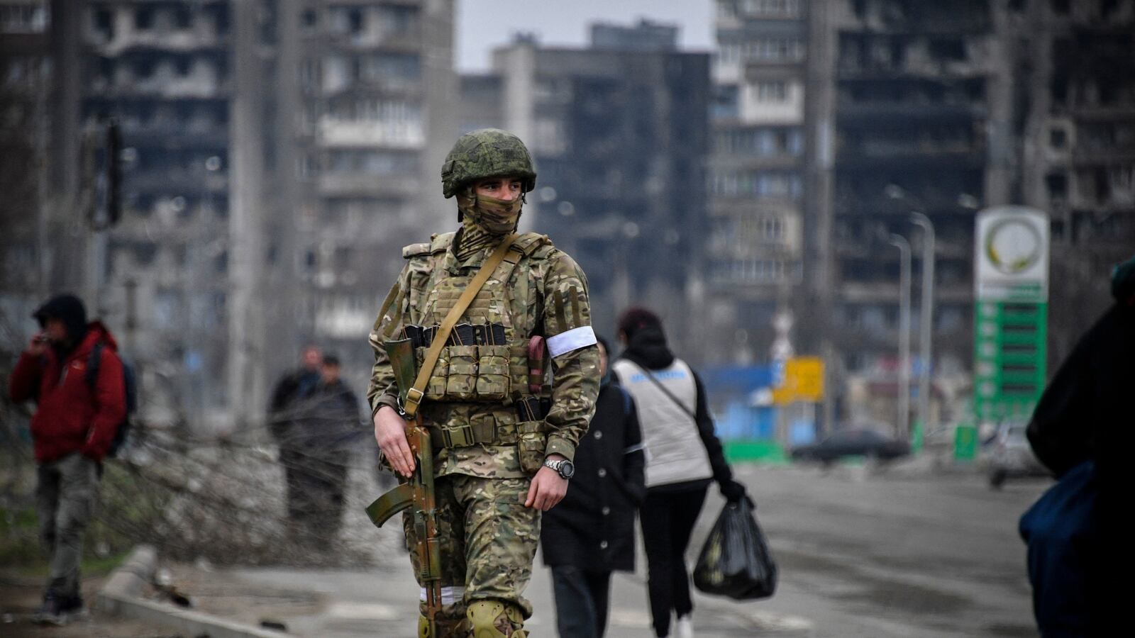 A Russian soldier patrols in a street of Mariupol