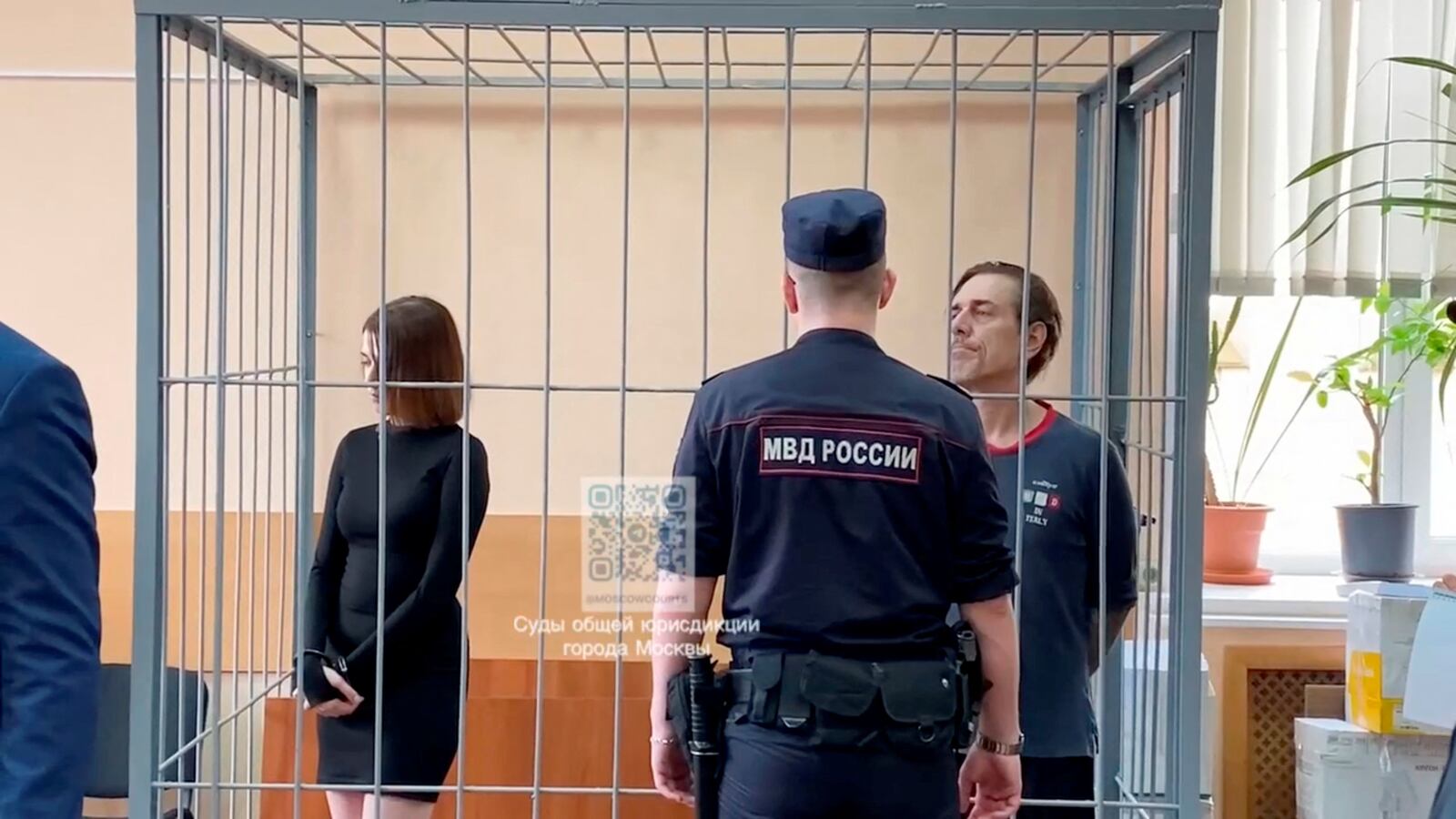 Russian citizen Veronika Grabanchuk and U.S. citizen Michael Travis Leake, accused of drug smuggling, stand inside an enclosure for defendants as they attend a court hearing in Moscow, Russia, in this still image from video, released on July 18, 2024.