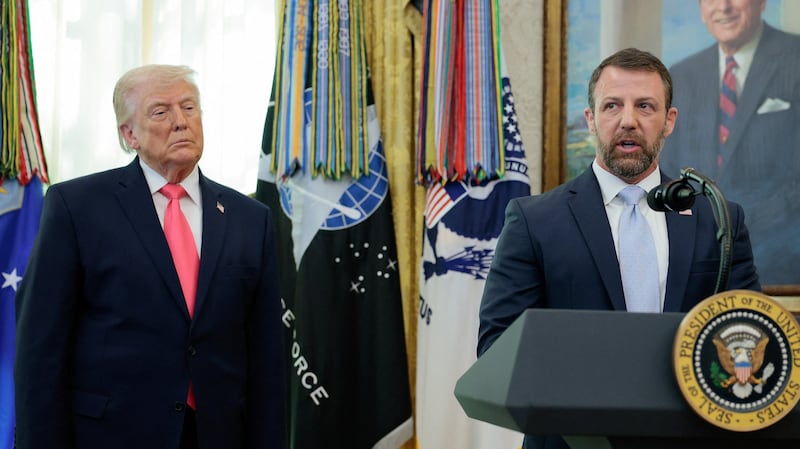 U.S. President Donald Trump flanks Markwayne Mullin as he speaks after being sworn in as Department of Homeland Security (DHS) Secretary at the White House in Washington, D.C., U.S., March 24, 2026.