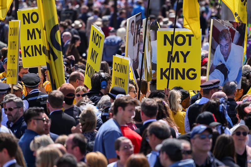 Demonstrators hold signs that read 'Not my King' and images showing Andrew Mountbatten-Windsor, formerly known as Prince Andrew, on the day of the Trooping the Colour parade to honour Britain's King Charles, as part of the official birthday celebrations, in London, Britain, June 13, 2026. REUTERS/Chris J. Ratcliffe