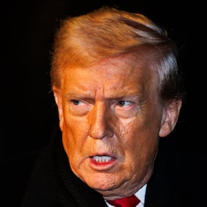 President Donald Trump walks over to reporters to make a brief statement before departing from the South Lawn of the White House in Marine One on January 20, 2026 in Washington, DC.