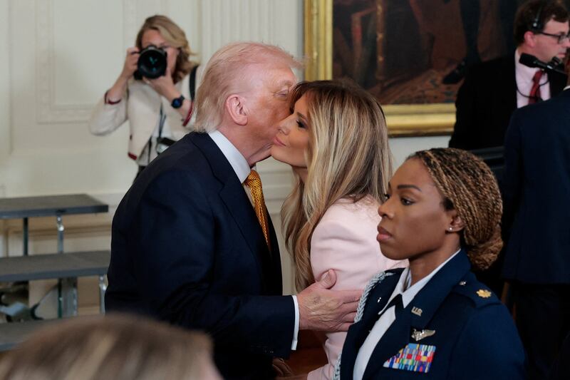 President Donald Trump kisses first lady Melania Trump at an event with military moms ahead of Mother's Day in the East Room at the White House on May 6, 2026.