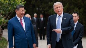 U.S. President Donald Trump gestures towards Chinese President Xi Jinping