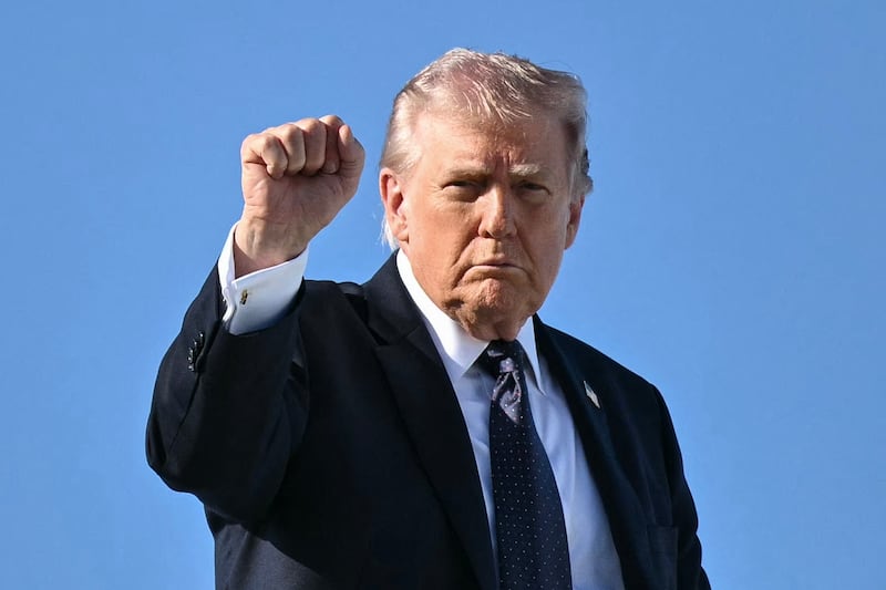 TOPSHOT - US President Donald Trump gestures as he boards Air Force One before departing Palm Beach International Airport in West Palm Beach, Florida, on March 1, 2026, on his way back to Washington, DC. The United States and Israel launched massive bombardments against Iran and killed its supreme leader on February 28, with attacks ongoing Sunday. The US military on Sunday said three service members have been killed and five seriously wounded in the war against Iran -- the first casualties announced on the US side. (Photo by Mandel NGAN / AFP via Getty Images)
