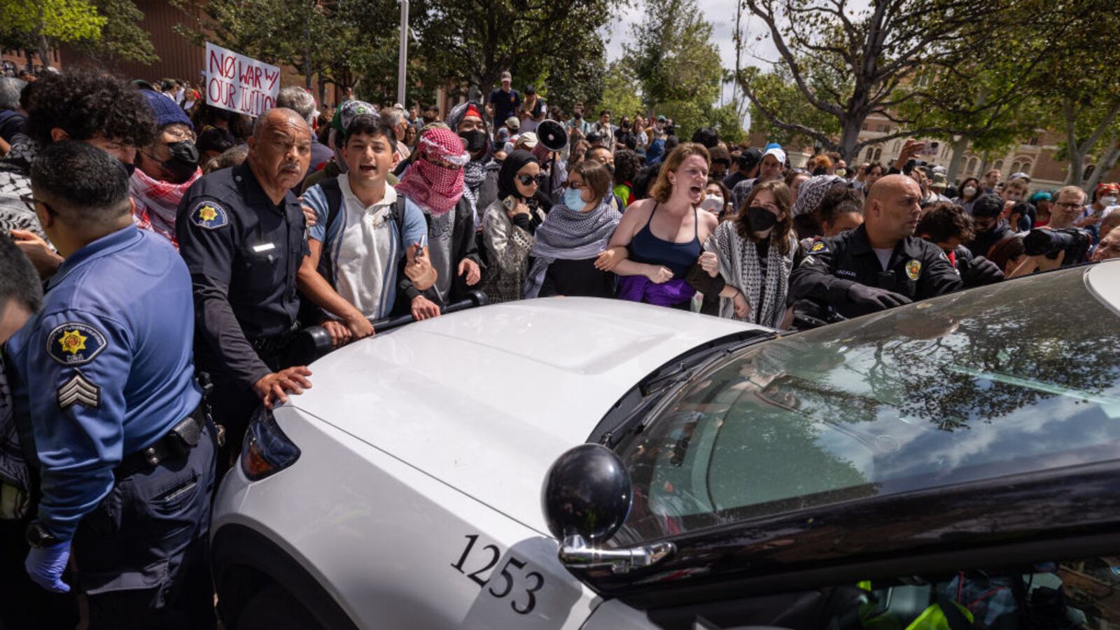 Pro-Palestinian demonstrators shout “Let him go!” after police took a man into custody at the University of Southern California on Wednesday.