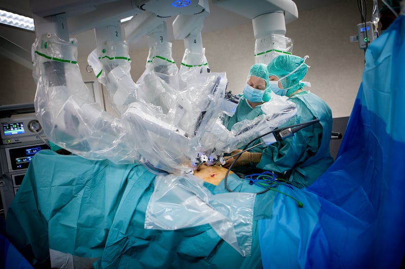 Reportage in an operating theatre during a hysterectomy using the da Vinci robot¬. A nurse and the surgeon position the robotÕs mechanical arm. (Photo by: BSIP/Universal Images Group via Getty Images)