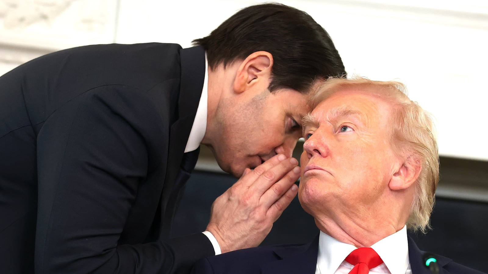 U.S. Secretary of State Marco Rubio (L) speaks to U.S. President Donald Trump