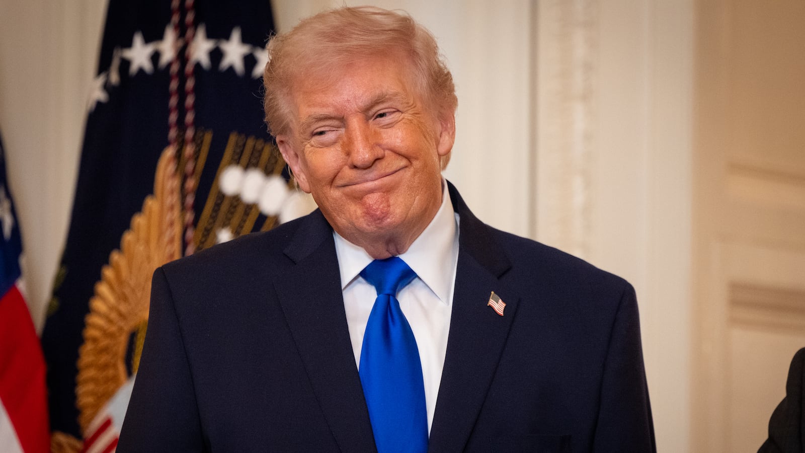 President Donald Trump listens as Laura Wilkerson speaks during the Angel Families Remembrance Ceremony in the East Room of the White House in Washington, DC on February 23, 2026.