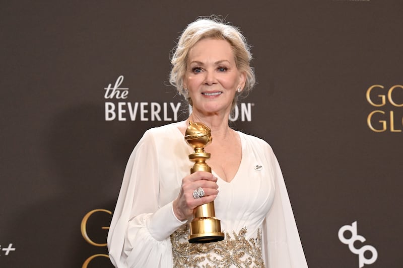 Jean Smart poses while wearing a "Be Good" pin honoring Renee Nicole Good during the 83rd Annual Golden Globe Awards.