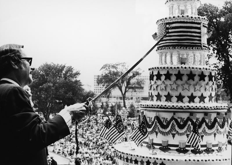 Dr James B. Rhoads, United States archivist, cuts the giant birthday cake honoring the 200th Anniversary of the signing of the Declaration of Independence during the American Bicentennial ceremonies, Washington, D.C., July 4, 1976.