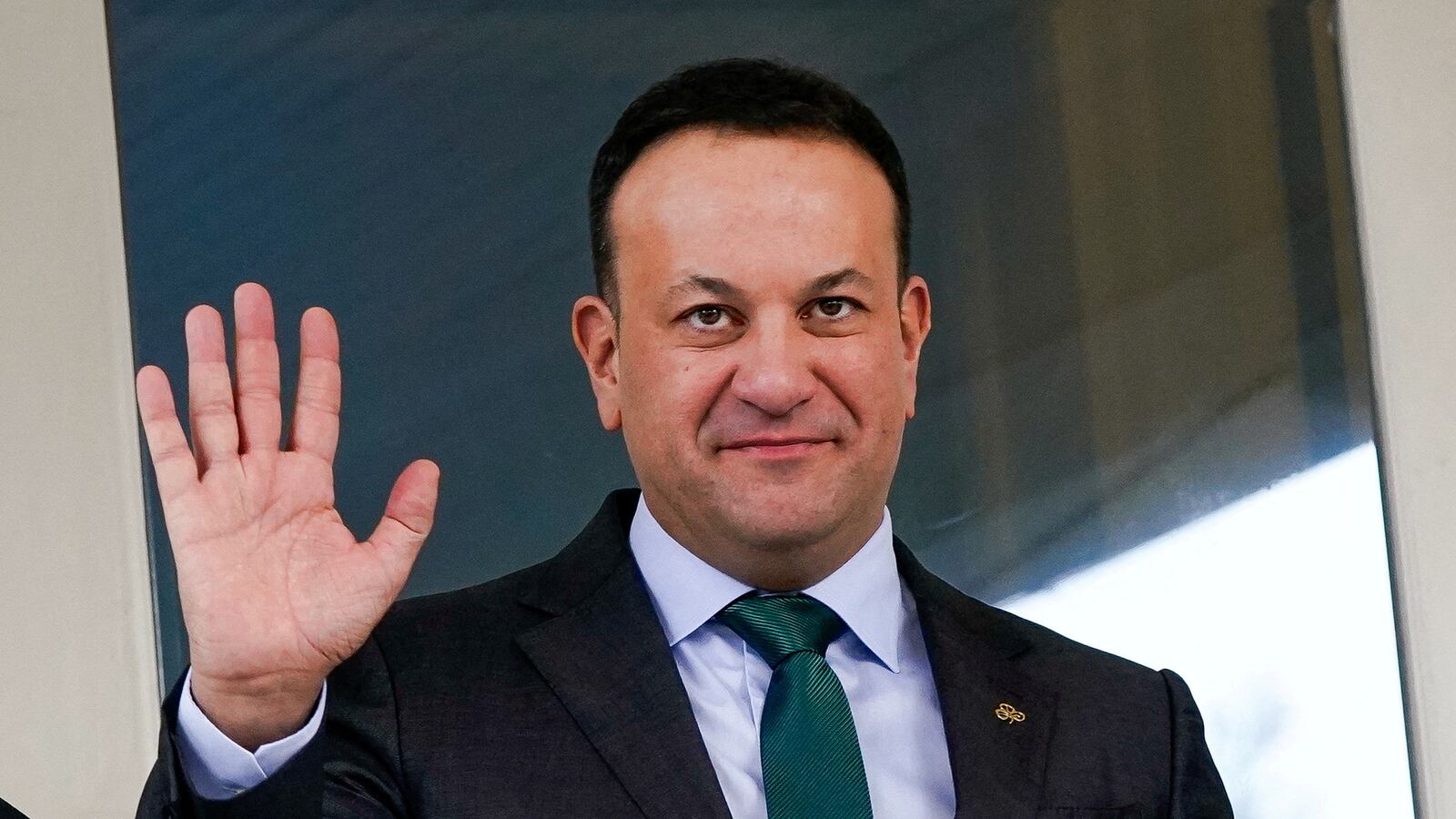 Leo Varadkar, wearing a suit and green tie, waves.