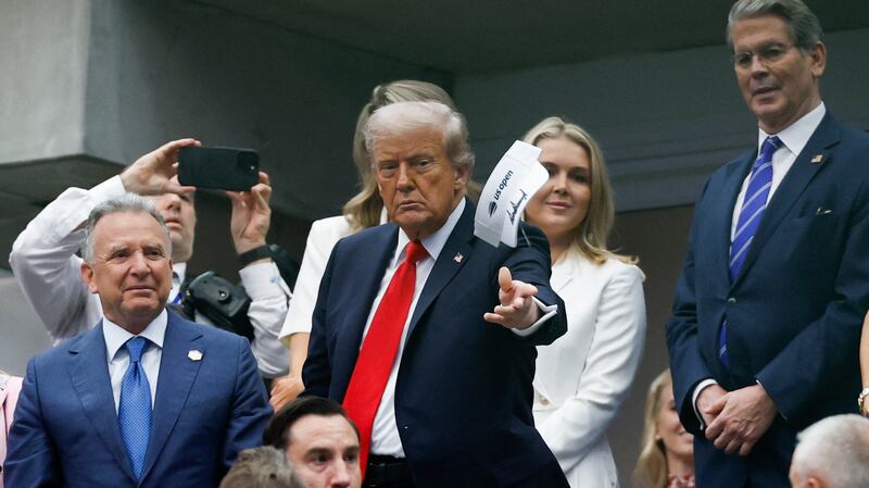 Sep 7, 2025; Flushing, NY, USA;  President Donald Trump throws an autographed visor after the final of mens singles at Billie Jean King National Tennis Center.