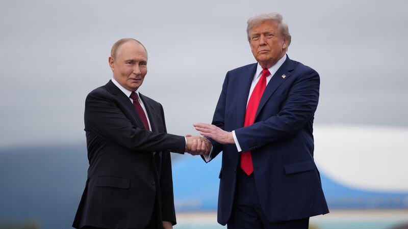 ANCHORAGE, ALASKA - AUGUST 15: U.S. President Donald Trump (R) greets Russian President Vladimir Putin as he arrives at Joint Base Elmendorf-Richardson on August 15, 2025 in Anchorage, Alaska. The two leaders are meeting for peace talks aimed at ending the war in Ukraine.  (Photo by Andrew Harnik/Getty Images)