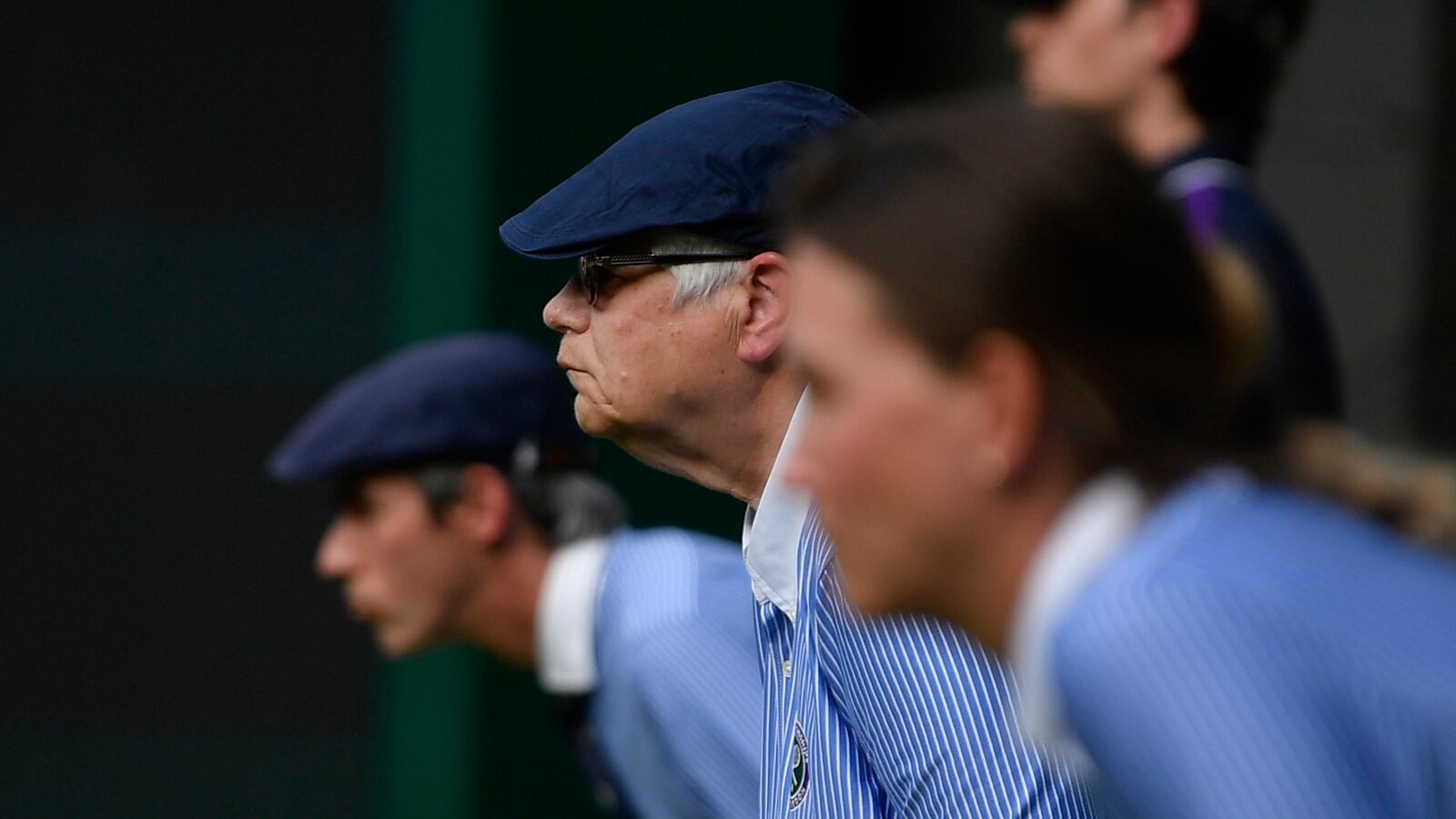 A photo of several Wimbledon line judges in a row. The tennis tournament is considering replacing its line judges with artificial intelligence.