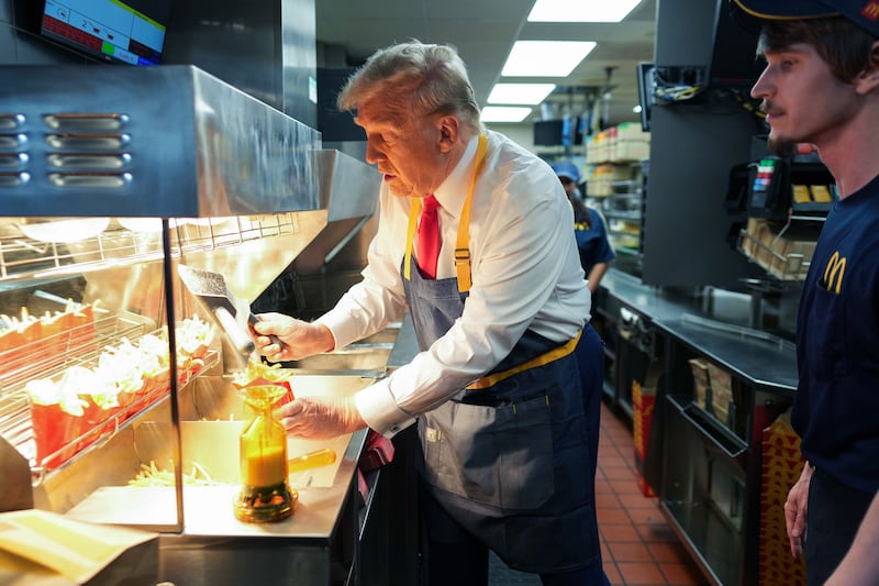 FEASTERVILLE-TREVOSE, PENNSYLVANIA - OCTOBER 20: Republican presidential nominee, former U.S. President Donald Trump works behind the counter making french fries during a campaign event at McDonald's restaurant on October 20, 2024 in Feasterville-Trevose, Pennsylvania. Trump is campaigning the entire day in the state of Pennsylvania. Trump and Democratic presidential nominee Vice President Kamala Harris continue to campaign in battleground swing states ahead of the November 5th election. (Photo by Doug Mills-Pool/Getty Images)