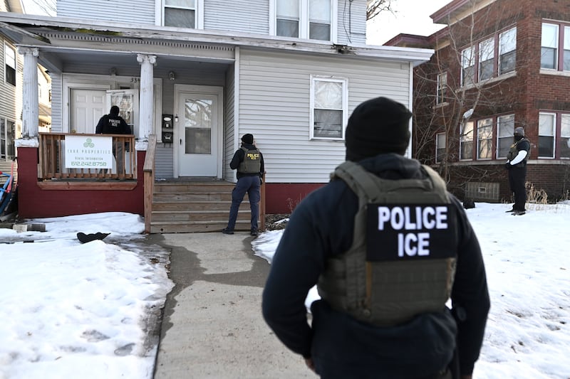 MINNEAPOLIS, MINNESOTA - JANUARY 13: ICE agents approach a house before detaining two people on January 13, 2026 in Minneapolis, Minnesota. The Trump administration has deployed over 2,400 Department of Homeland Security agents to the state of Minnesota in a push to apprehend undocumented immigrants. (Photo by Stephen Maturen/Getty Images)