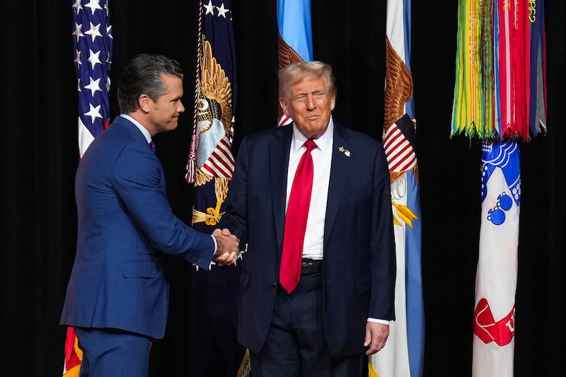 QUANTICO, VIRGINIA - SEPTEMBER 30: (EDITOR'S NOTE: Alternate crop) U.S. President Donald Trump (R) greets U.S. Secretary of War Pete Hegseth as he arrives to speak to senior military leaders at Marine Corps Base Quantico on September 30, 2025 in Quantico, Virginia. In an unprecedented gathering, almost 800 generals, admirals and their senior enlisted leaders have been ordered into one location from around the world on short notice. (Photo by Andrew Harnik/Getty Images)