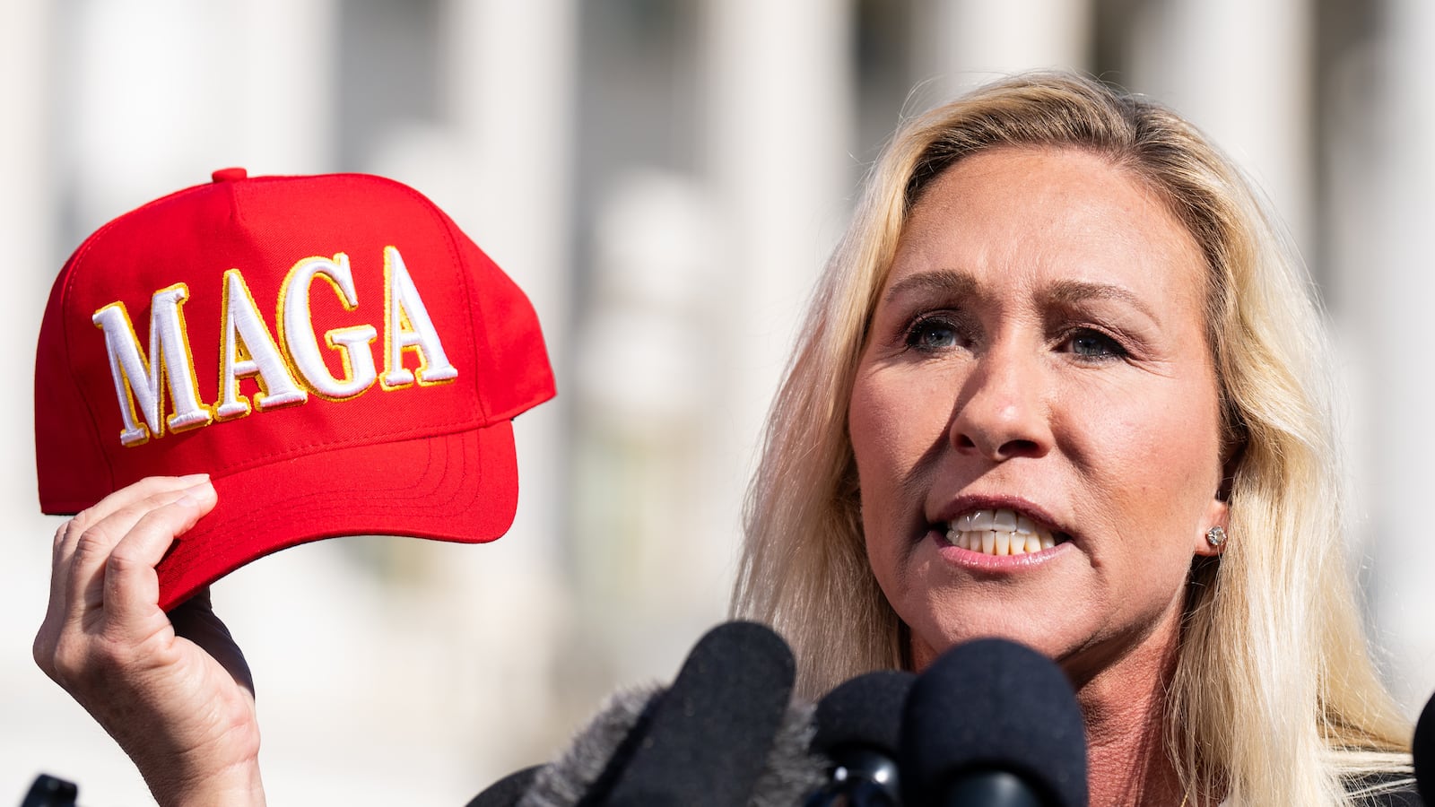 Rep. Marjorie Taylor Greene, R-Ga., holds her "Make America Great Again" hat during the news conference outside the U.S. Capitol on Wednesday, May 1, 2024.