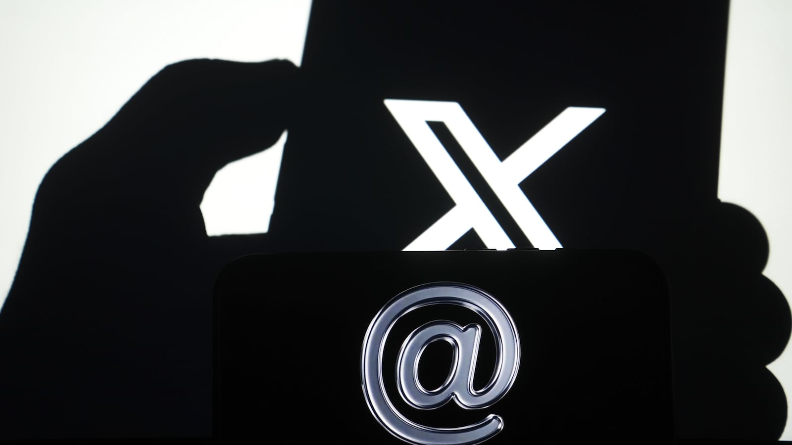 ANKARA, TURKIYE - NOVEMBER 6: In this photo illustration X logo is displayed on a mobile phone screen with an '@' sign blurred in the background in Ankara, Turkiye on November 6, 2025. (Photo by Metin Aktas/Anadolu via Getty Images)