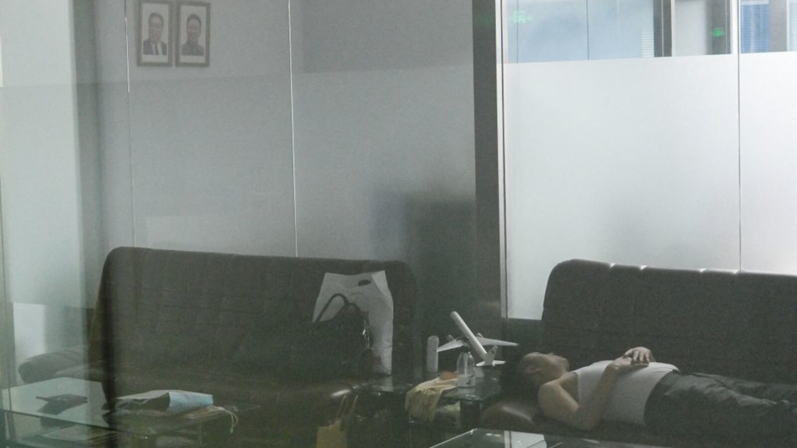 A man sleeps in a closed Air Koryo office in Beijing on Aug. 21, 2023. North Korea's national airline was set to make its first commercial flight in over three years on Aug. 21, only to be abruptly canceled at the last minute.