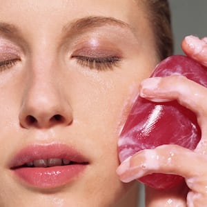 A woman cleansing her skin