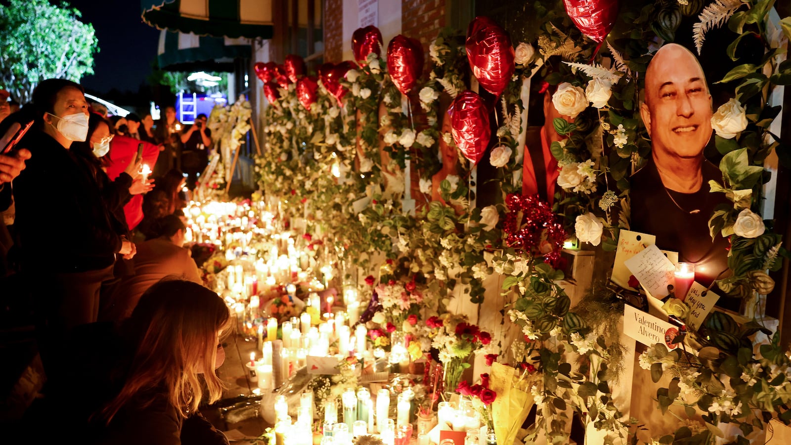 Monterey Park shooting victims' pictures are displayed at a candlelight vigil.