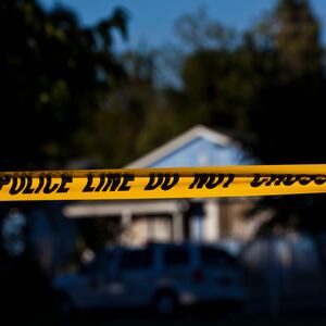 Police tape is put up in front of a California house.