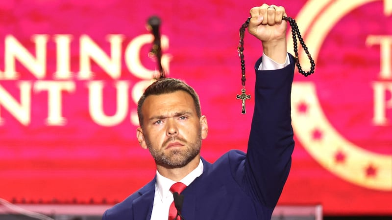 US political activist Jack Posobiec holds up a rosary as he speaks during the public memorial service for right-wing activist Charlie Kirk