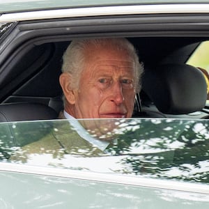 Britain's King Charles sits in a car on the day of his visit at the The Royal Society for the Protection of Birds.