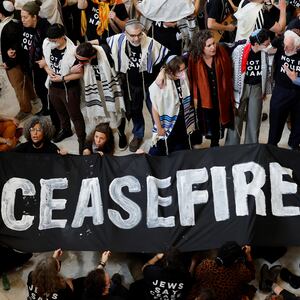 A photo of protesters calling for a cease fire in Gaza and an end to the Israel-Hamas conflict as they occupied the rotunda of the Cannon House office building with a banner reading: “CEASEFIRE.”