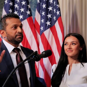 FBI Director Kash Patel speaks as his girlfriend Alexis Wilkins (C) looks on during his swearing-in ceremony on Feb. 21, 2025, in Washington, DC.