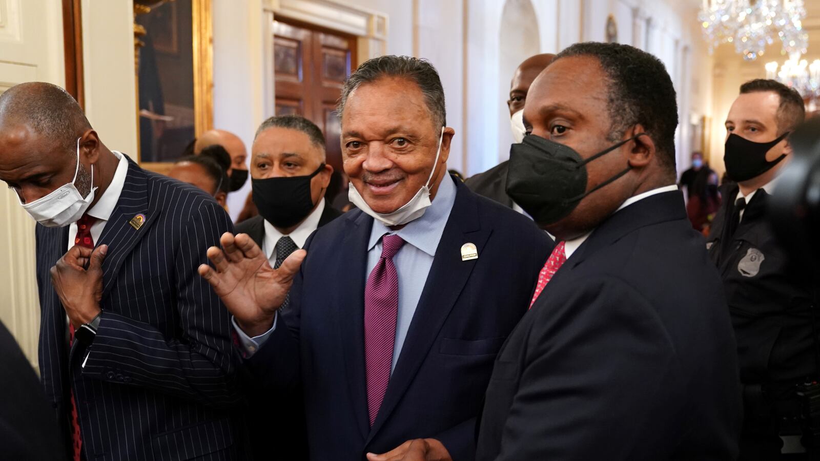 Photo of Jesse Jackson walking through halls of Congress